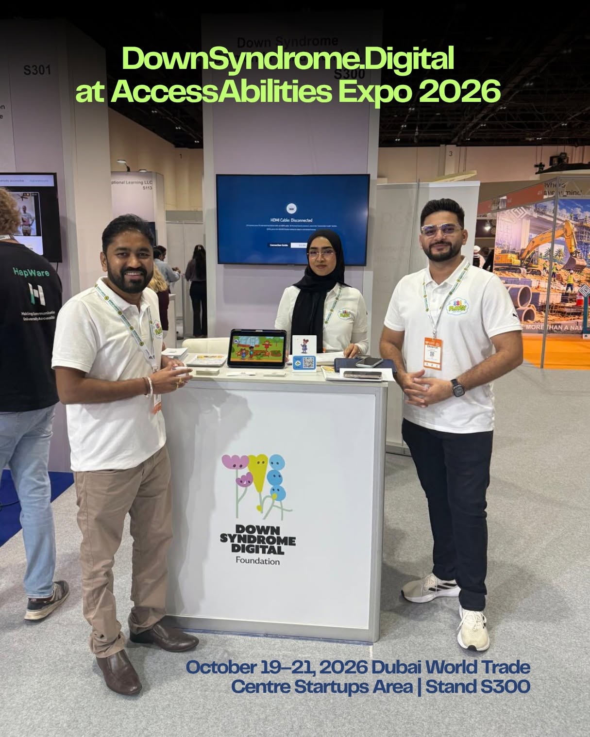The Down Syndrome Digital team at its AccessAbilities Expo 2026 booth, with 321 Playsy displayed on a tablet.