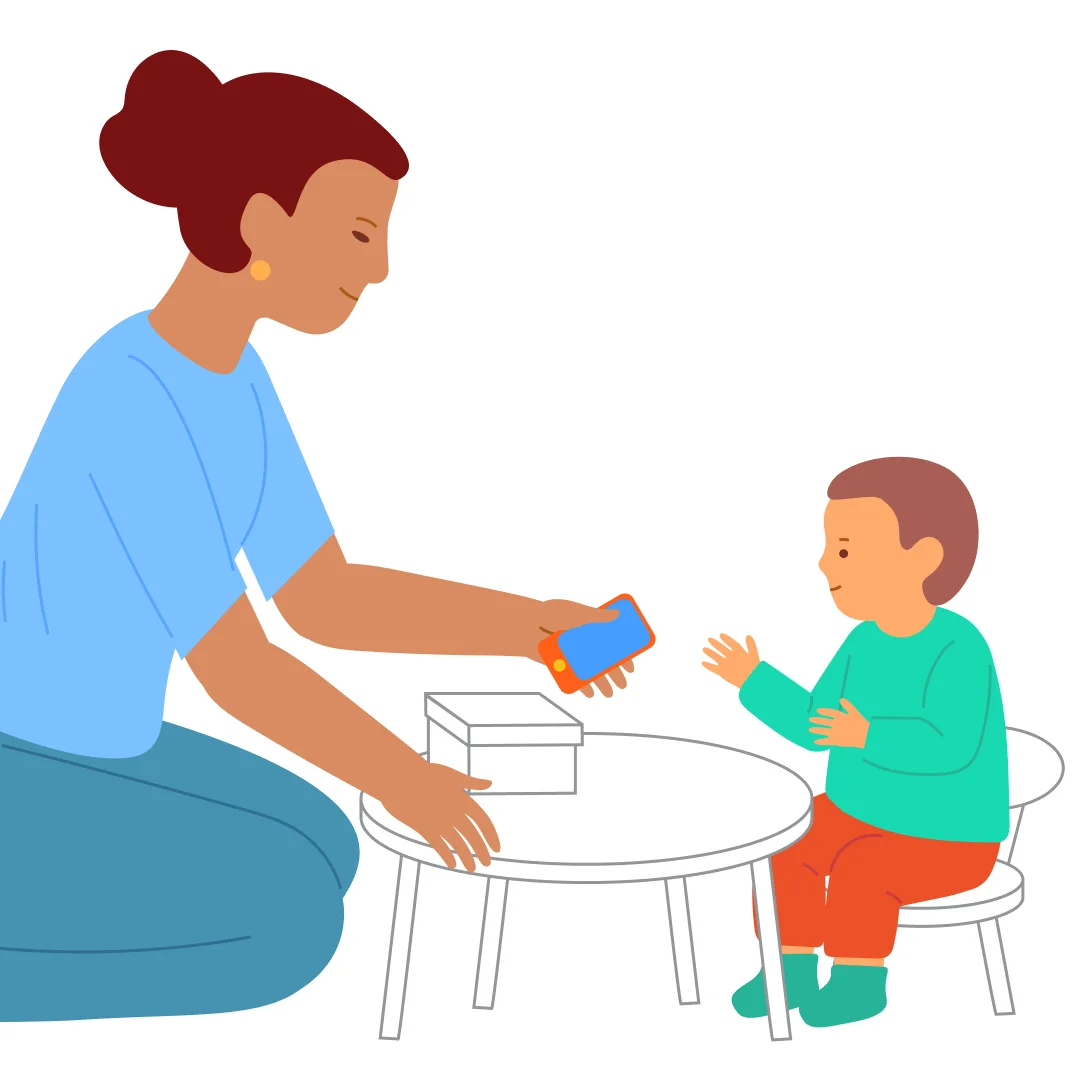 Illustration for ““We Hid! Find Us!””, step 1: Sit on the same level with your child—at a table, on the floor, or on the couch.