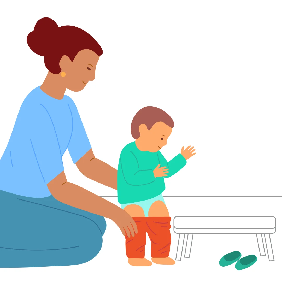 Illustration for “Undress Before Bed”, step 2: Place both shoes nearby and praise them: “Great job, you took off your shoes!” Help the child stand up by taking their hands: “Stand on your feet!” Pull their pants down just above the knees.
